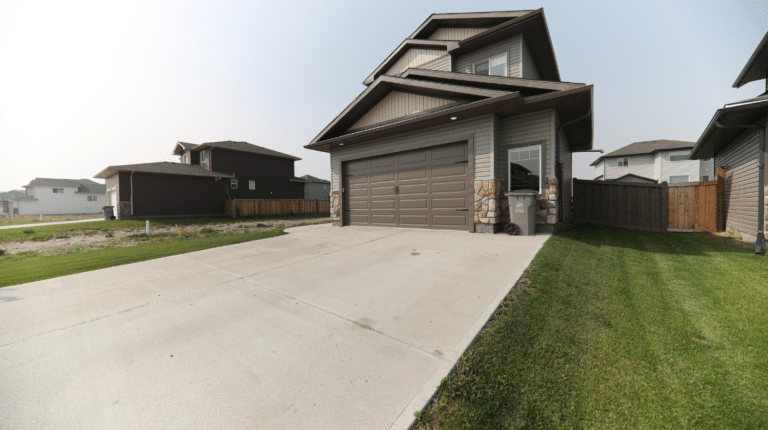 Concrete driveway contractors in Colorado installed a sleek, durable driveway for a modern residential home.