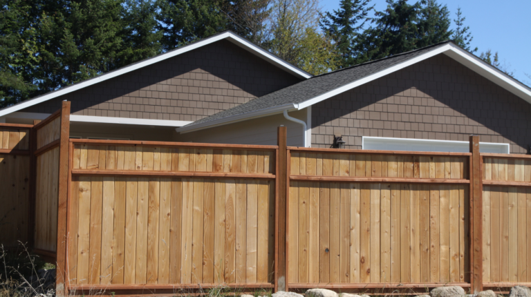 Fence contractors in Colorado built a natural wooden privacy fence to enhance curb appeal and provide backyard security