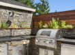 Custom outdoor kitchen with stone countertops and built-in grill