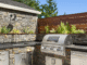 Custom outdoor kitchen with stone countertops and built-in grill