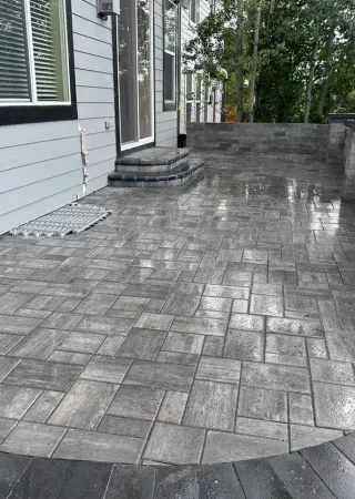 Custom stone paver patio with curved edges and stone retaining wall