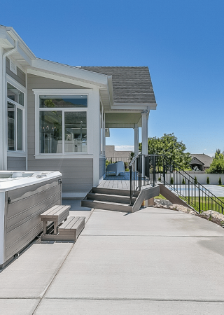 Concrete patio contractors in Aurora CO built this backyard patio with a hot tub, offering a durable and stylish outdoor living space