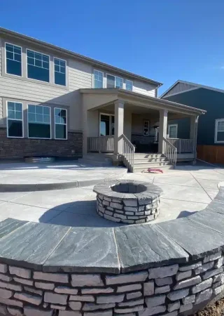 Fire pit installation in Colorado featuring a durable stone-built fire pit as the centerpiece of a backyard patio.